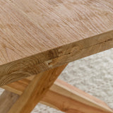 close up view of wood grain for solid teak wood dining table with cross legs