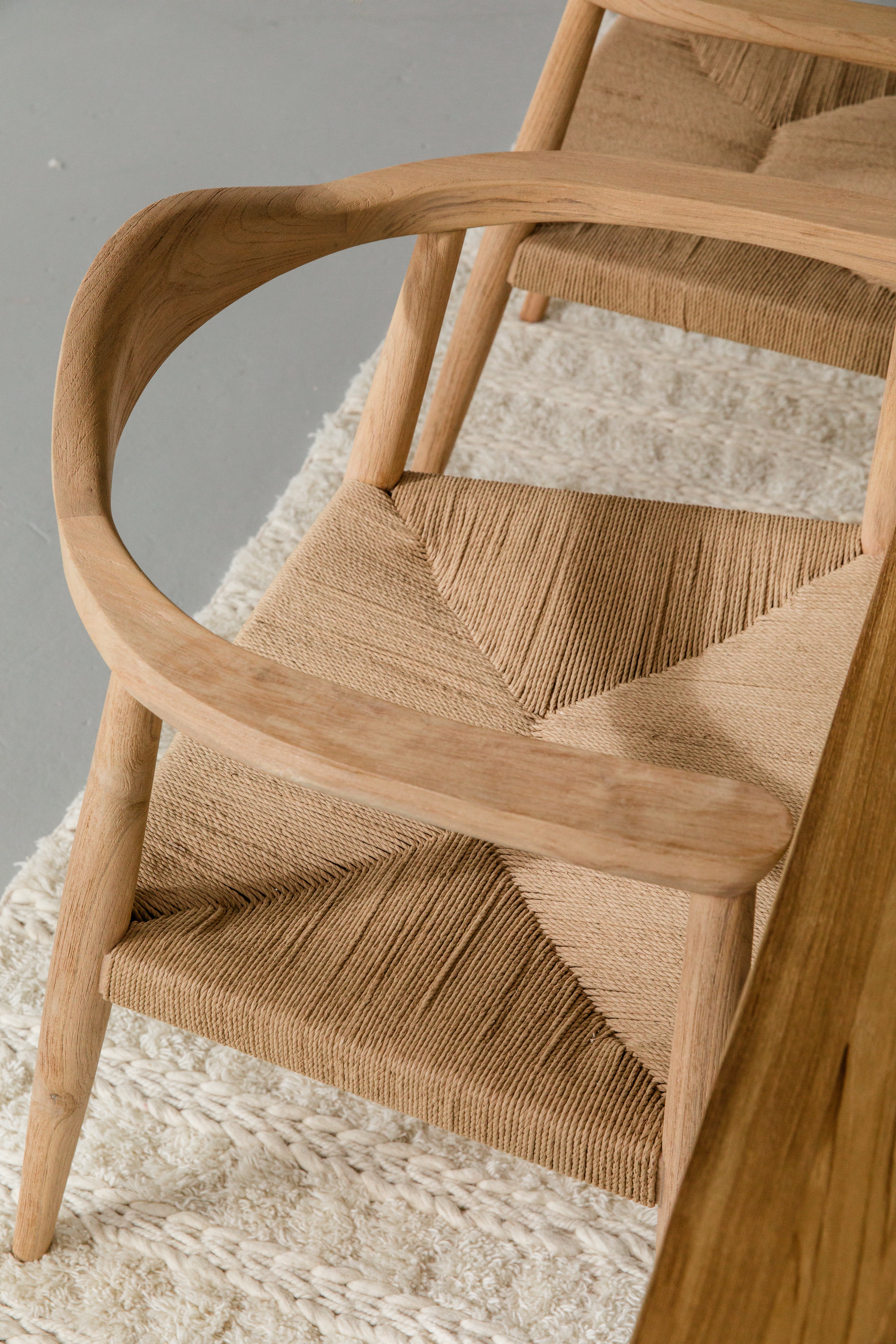 close up view of light wooden dining room chairs with jute rope woven seats