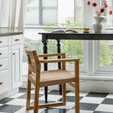 Paris-inspired kitchen nook with a natural wooden and textural arm chair
