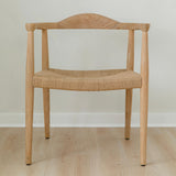 modern natural wooden dining room chair with a curved back and a jute rope woven seat