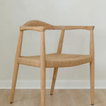 angular view of a natural light wooden chair with a jute rope woven seat