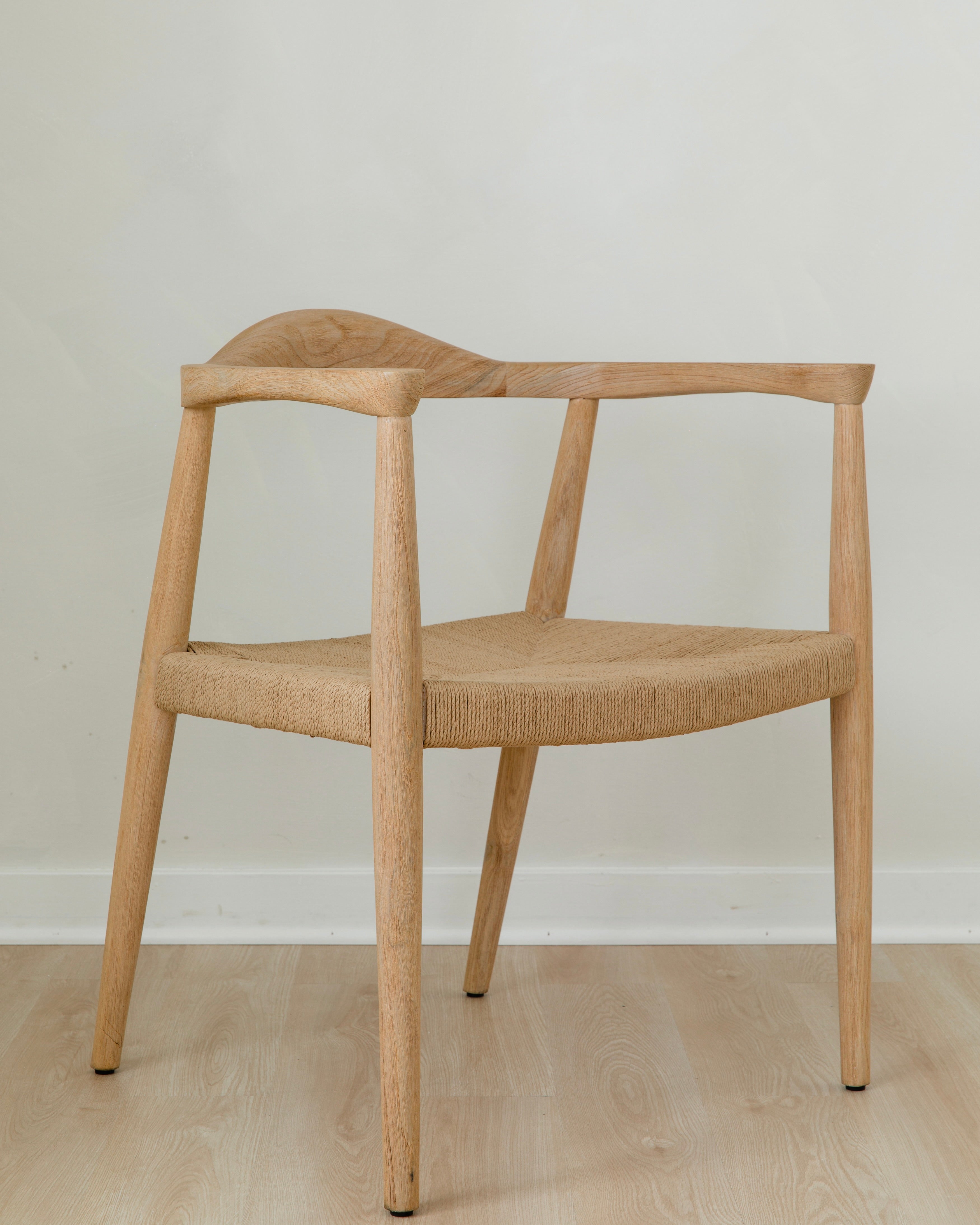 angular view of a natural light wooden chair with a jute rope woven seat