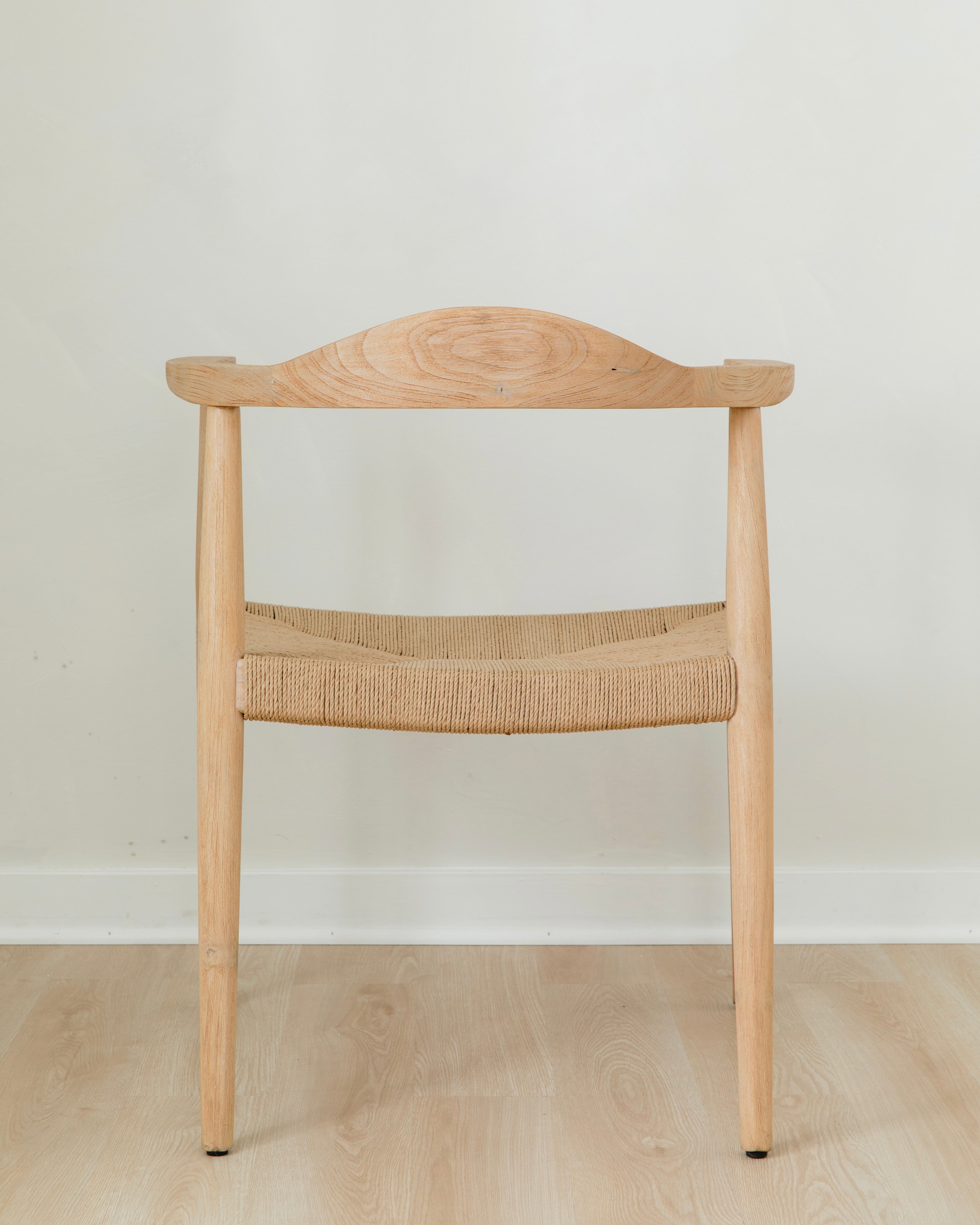 back view of a natural light wooden chair with a jute rope woven seat that's sustainable