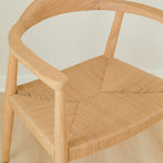close up view of a natural light wooden chair with a jute rope woven seat that's sustainable