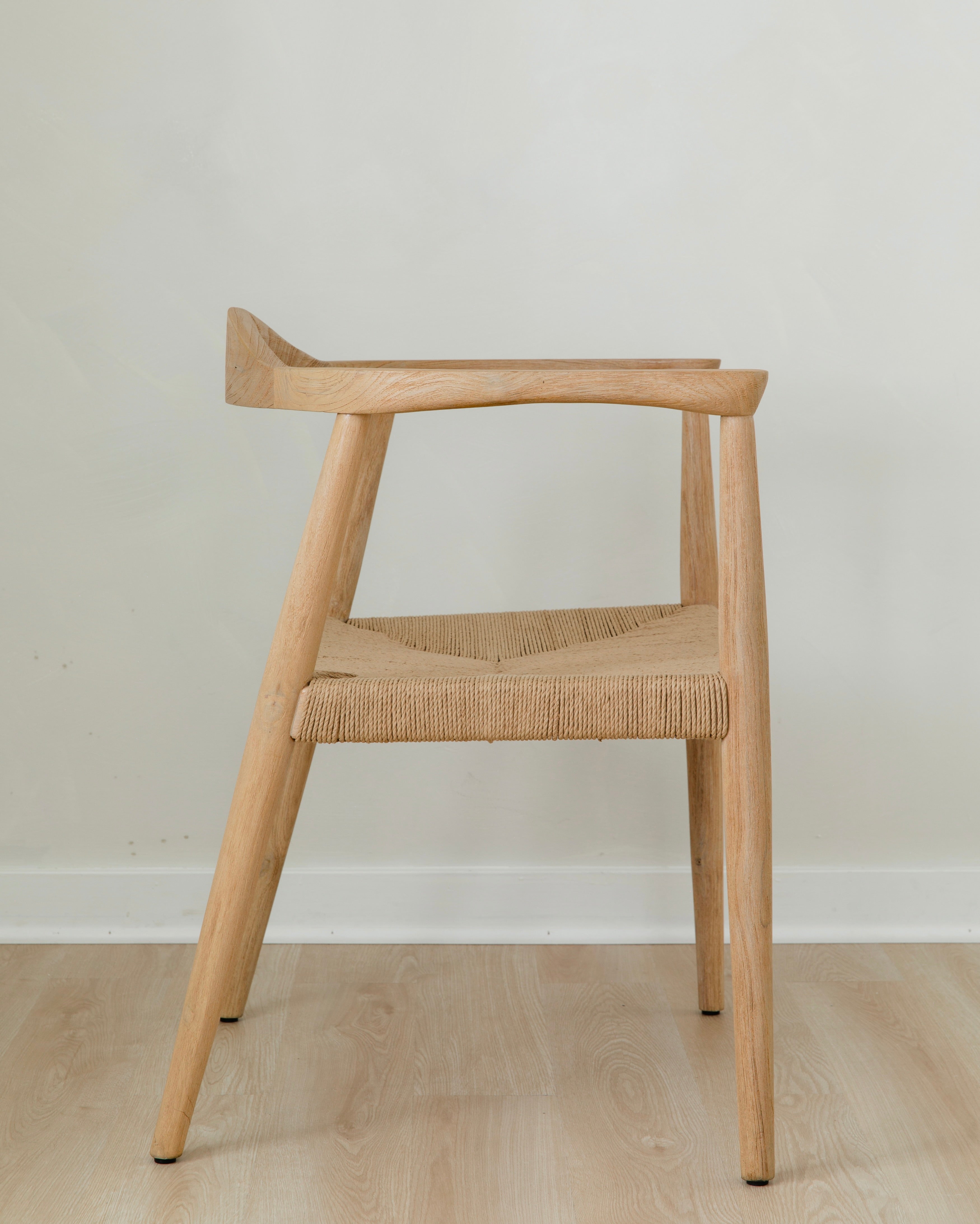 side view of a natural light wooden chair with a jute rope woven seat