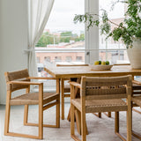 Natural solid wood dining table and chairs in a light and airy aesthetic