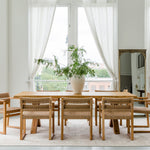 sustainable solid wood dining table and chairs in a dining room light and bright setting