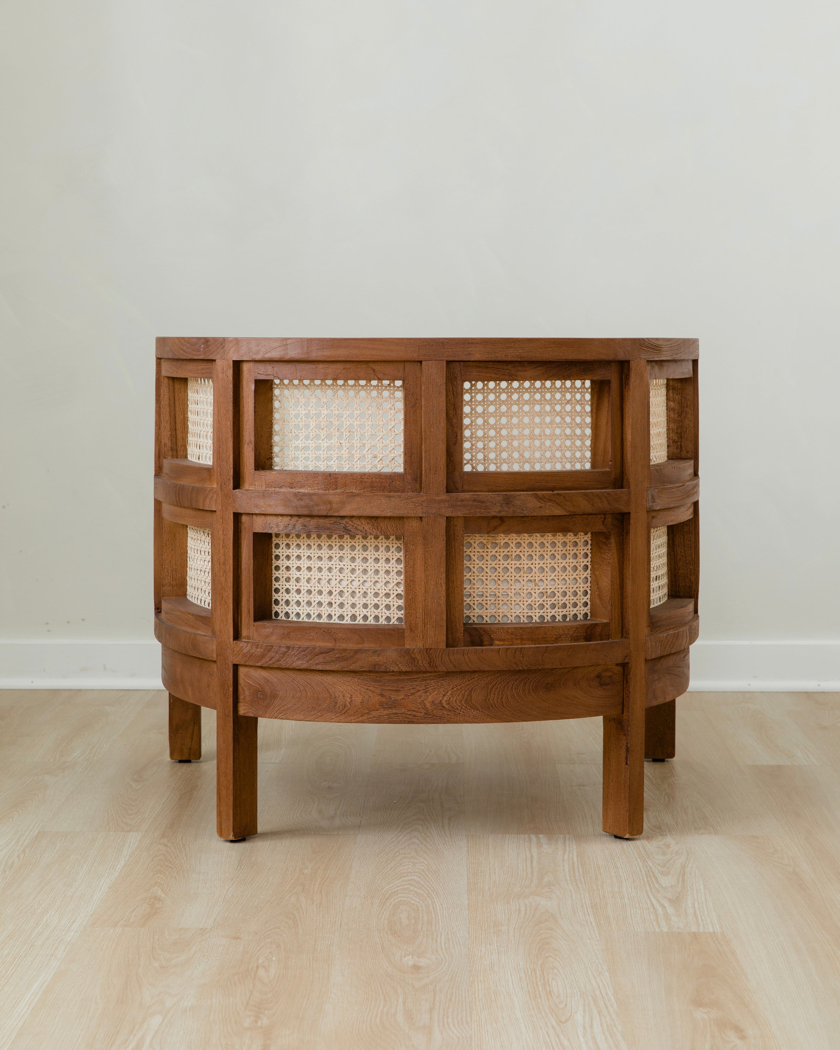 back view of curved and caned accent chair in a club style with a walnut wooden stain finish and white cushion