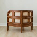 side view of curved and caned accent chair in a club style with a walnut wooden stain finish and white cushion