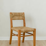 angular view of classic wooden chair in a honey stain with a woven seagrass back and seat