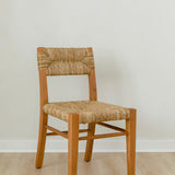 angular view of classic wooden chair in a honey stain with a woven seagrass back and seat