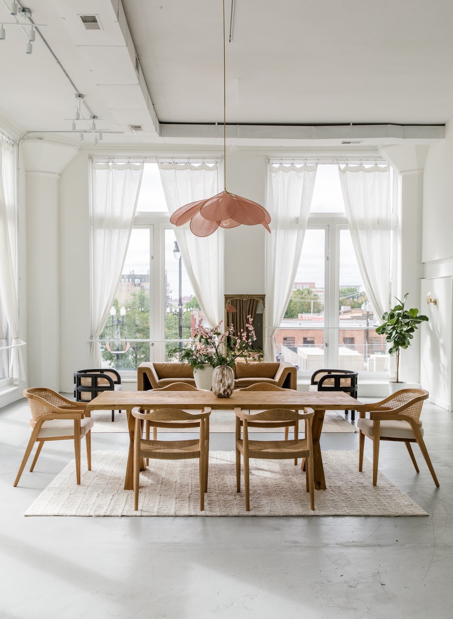 Open concept living/dining room in a modern, bright, and airy style with natural wooden elements throughout