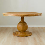 curvy solid wood round dining table with round pedestal base in mango wood
