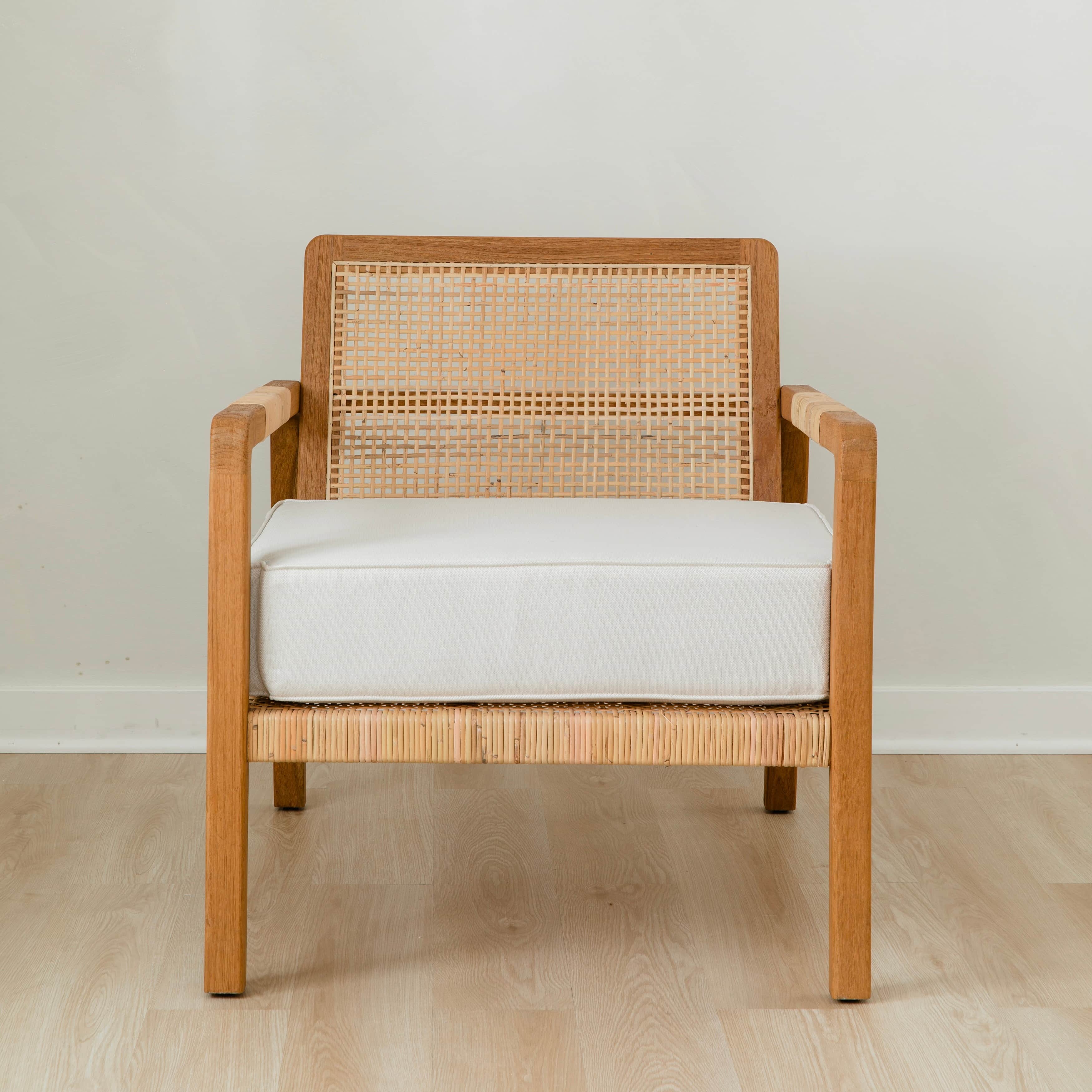 sustainable, handcrafted accent chair in rattan, with a modern, classic white cushion 