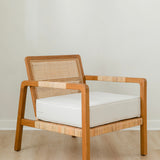 sustainable, handcrafted accent chair in rattan, with a modern, classic white cushion