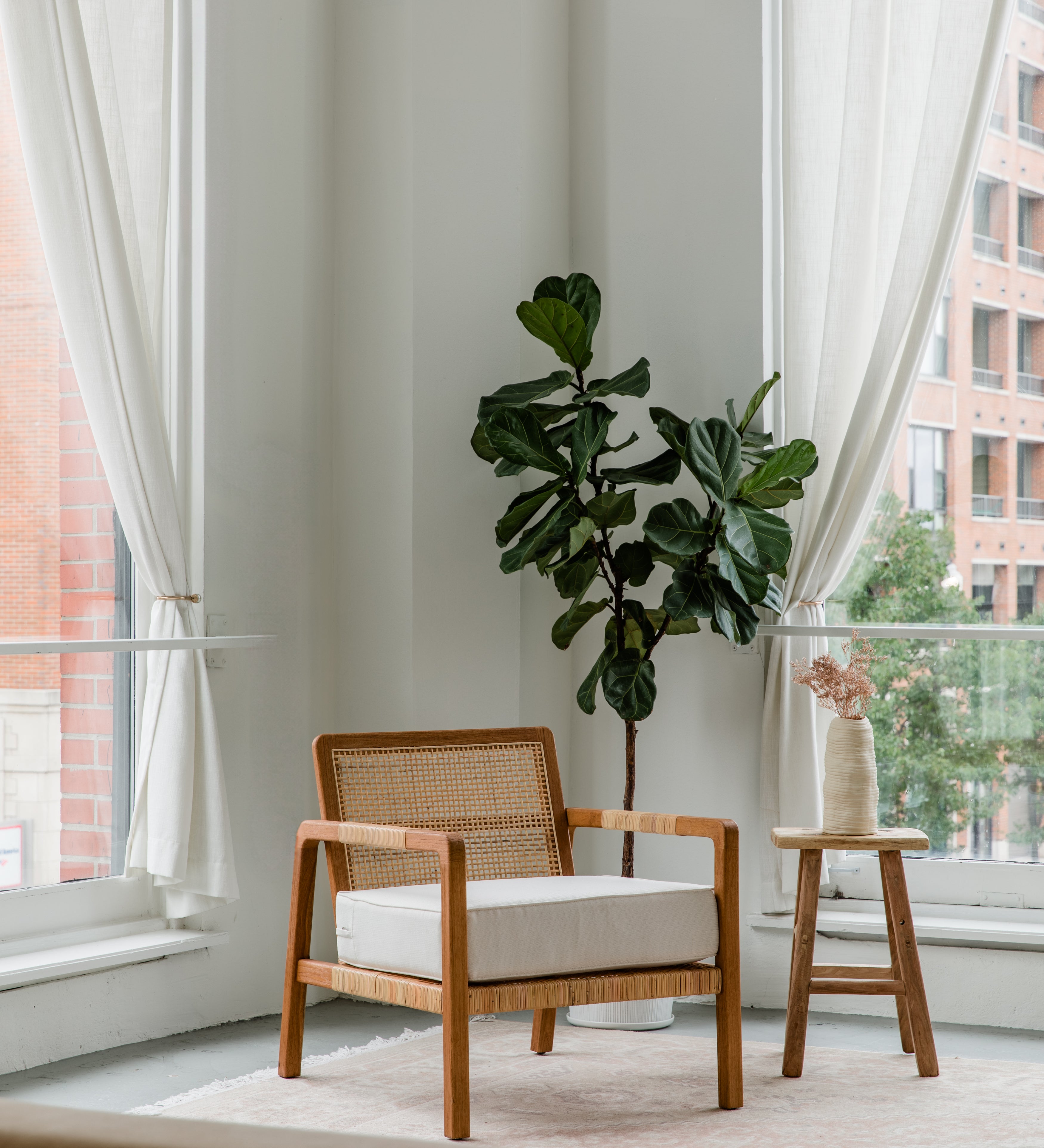 modern rattan and teak arm chair in a chic loft with natural accents