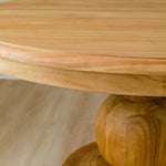 close up of wood grain for round dining table with a round ball pedestal base in mango wood