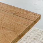 close up view of wood grain for solid teak wood dining table with cross legs