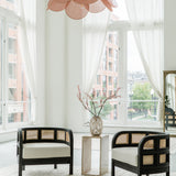 Black and white living room scene with matte black accent chairs 