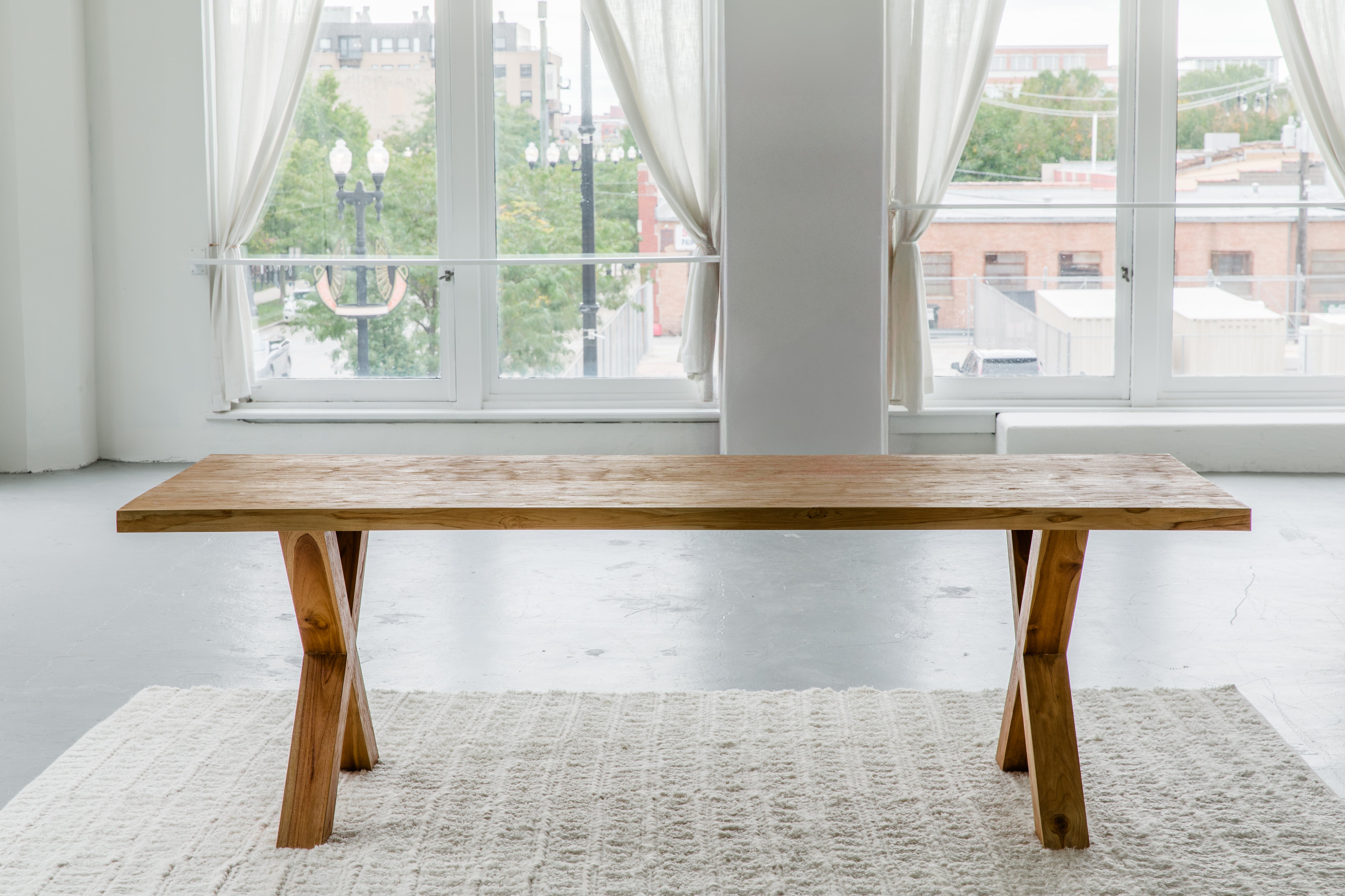 solid teak wood rectangular dining table with cross legs made from sustainable materials