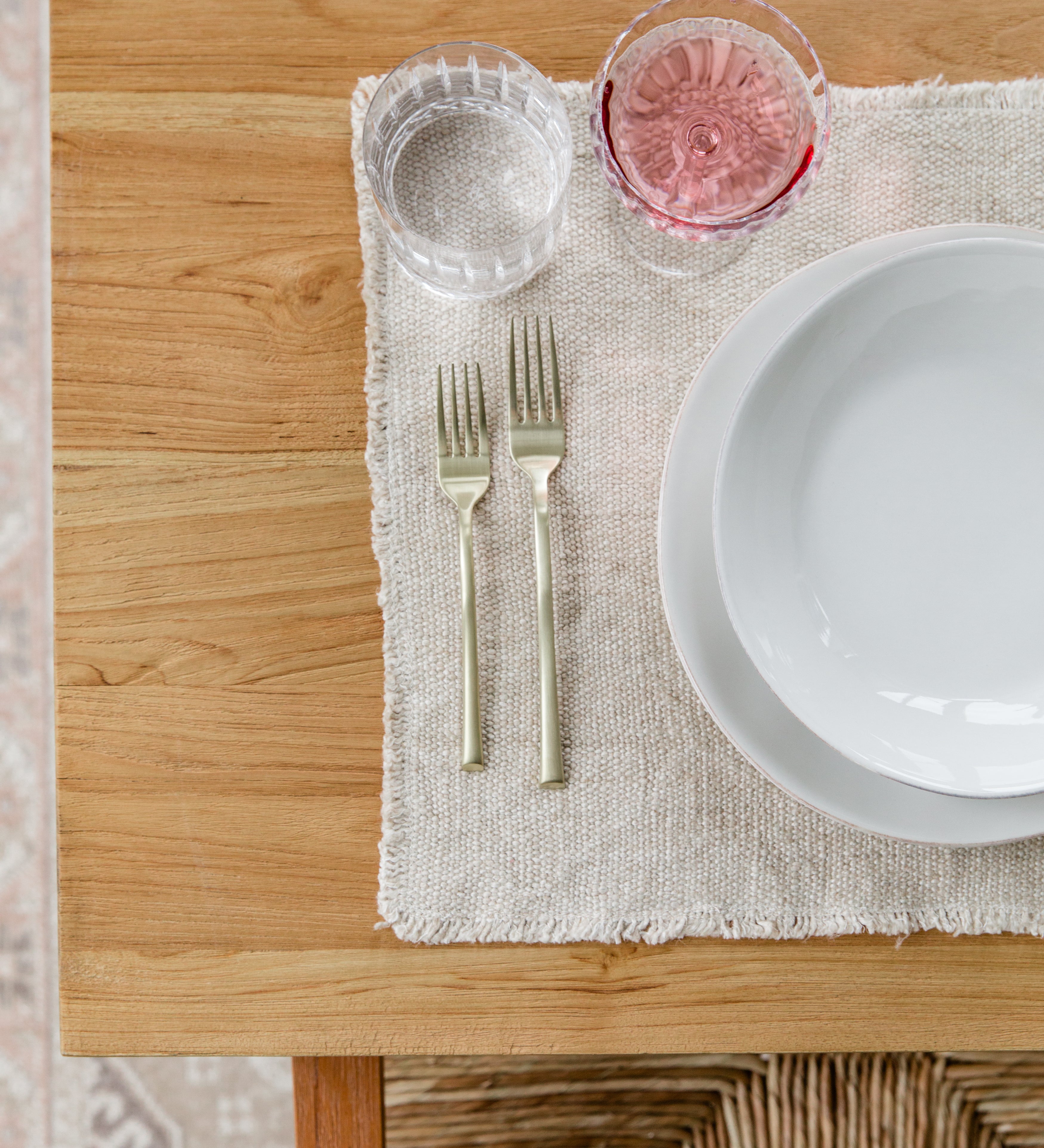 Close up view of a table setting on a natural wood grain table