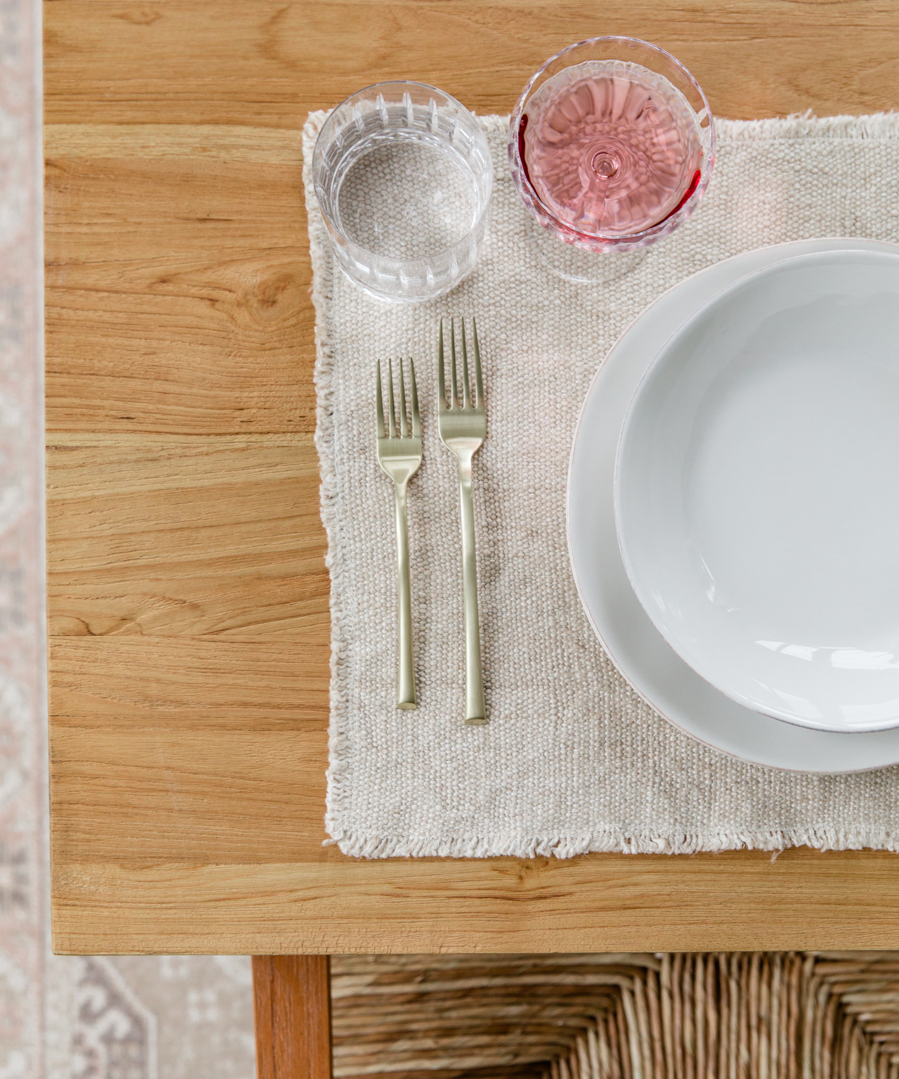 Close up view of a table setting on a natural wood grain table