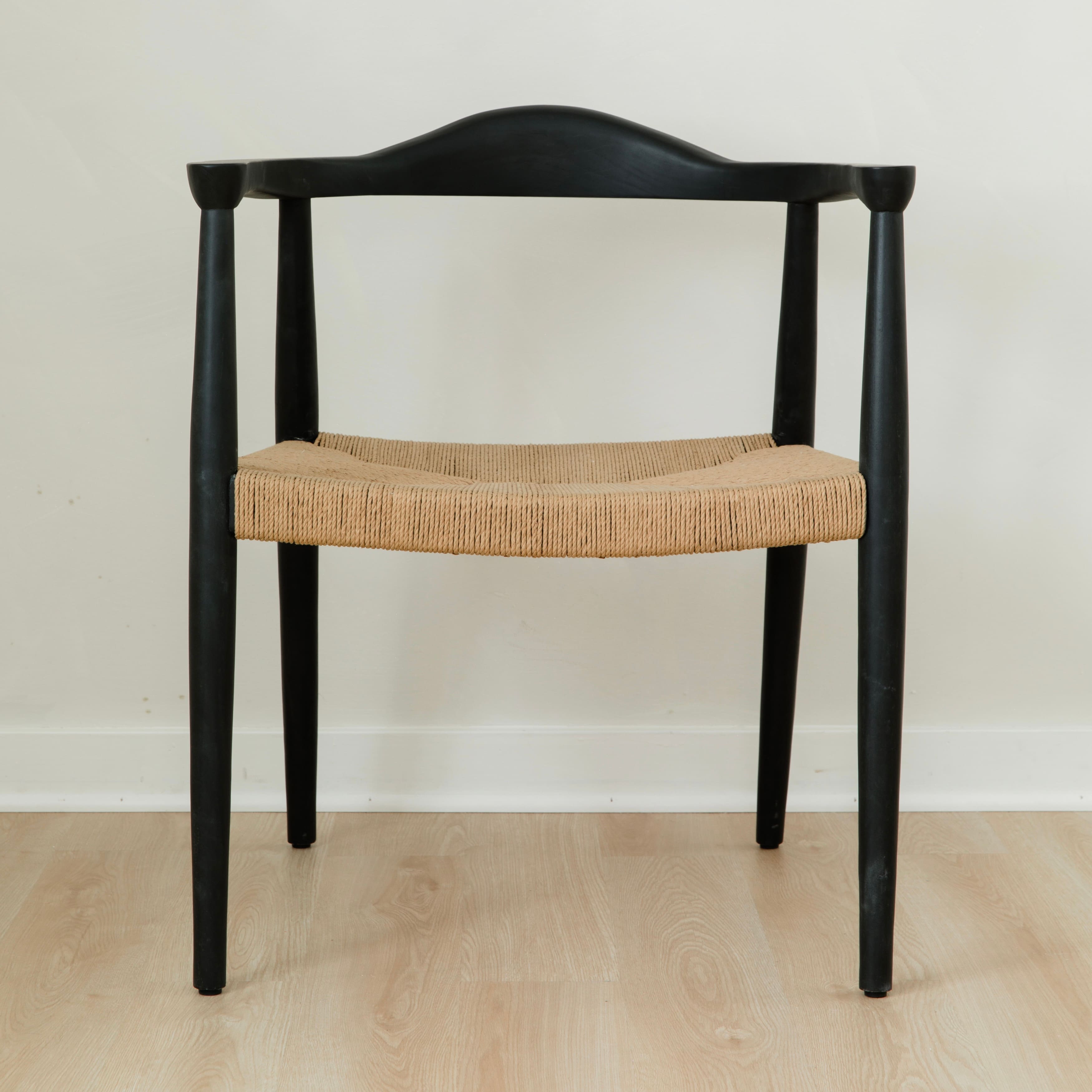 modern matte black dining room chair with a curved back and a jute rope woven seat