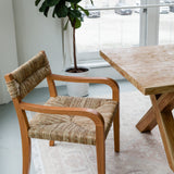 modern yet timeless dining room set up highlighting a woven seagrass dining chair with arms