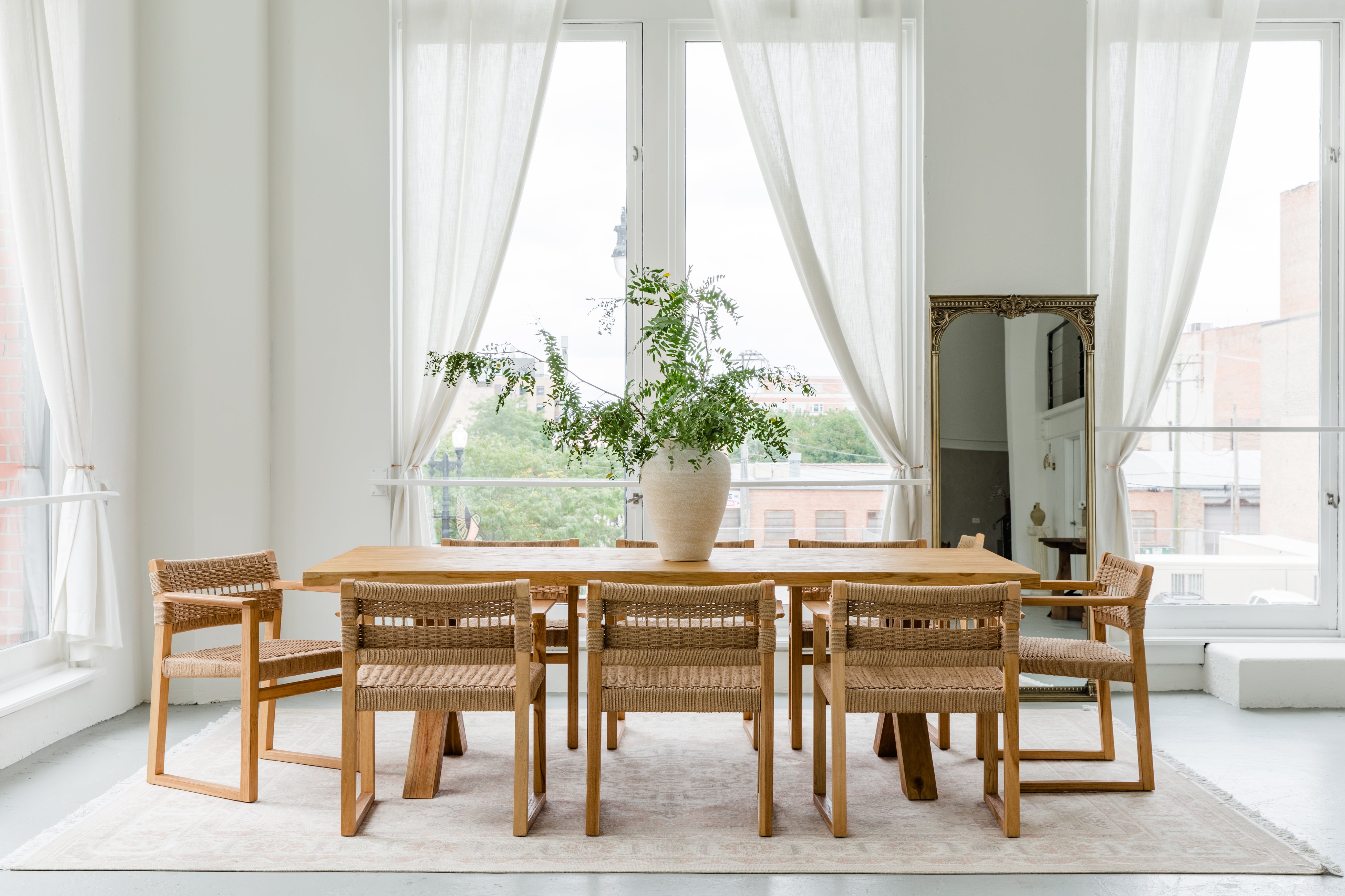 sustainable solid wood dining table and chairs in a dining room light and bright setting