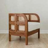 angular view of curved and caned accent chair in a club style with a walnut wooden stain finish and white cushion