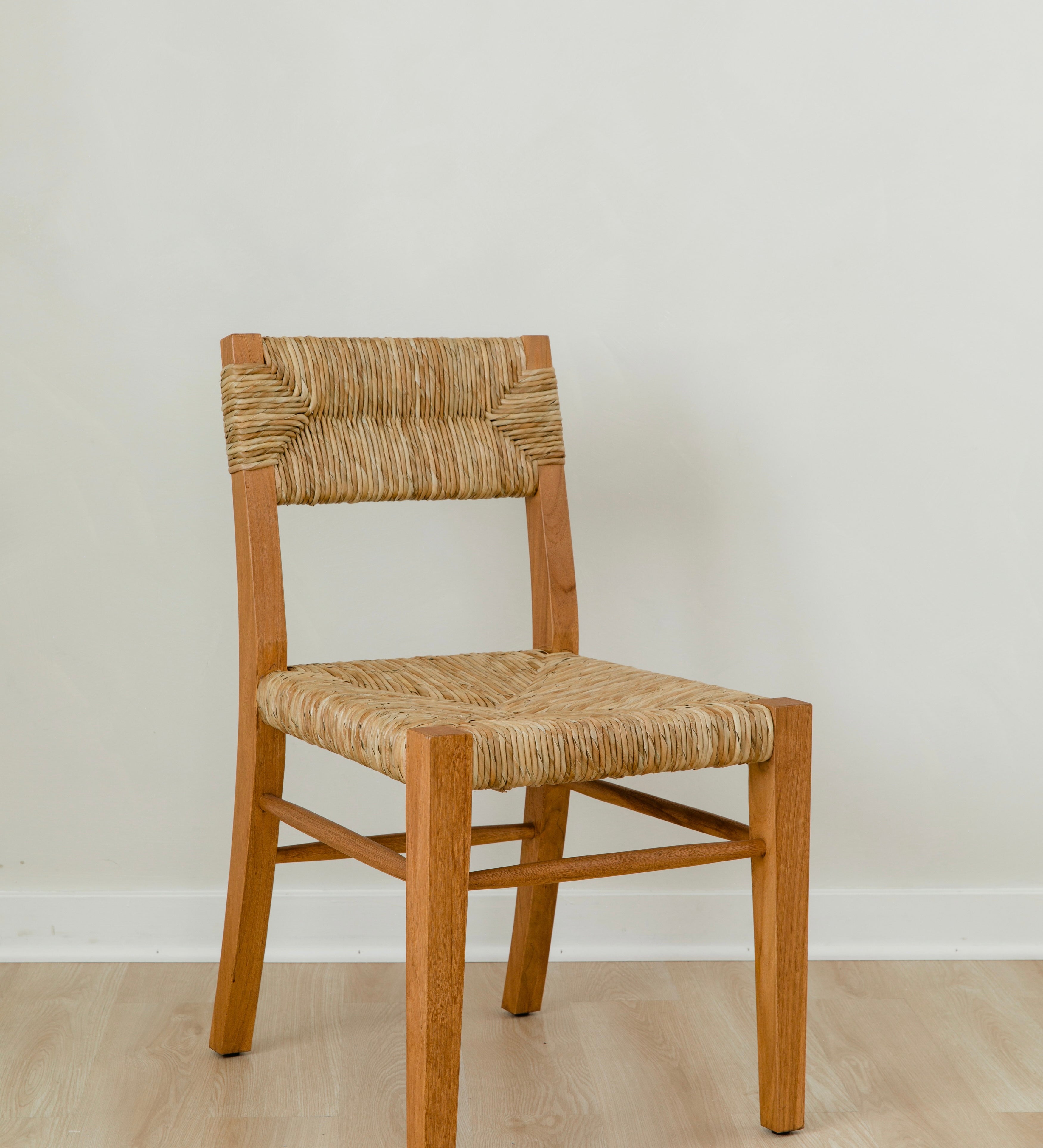 angular view of classic wooden chair in a honey stain with a woven seagrass back and seat